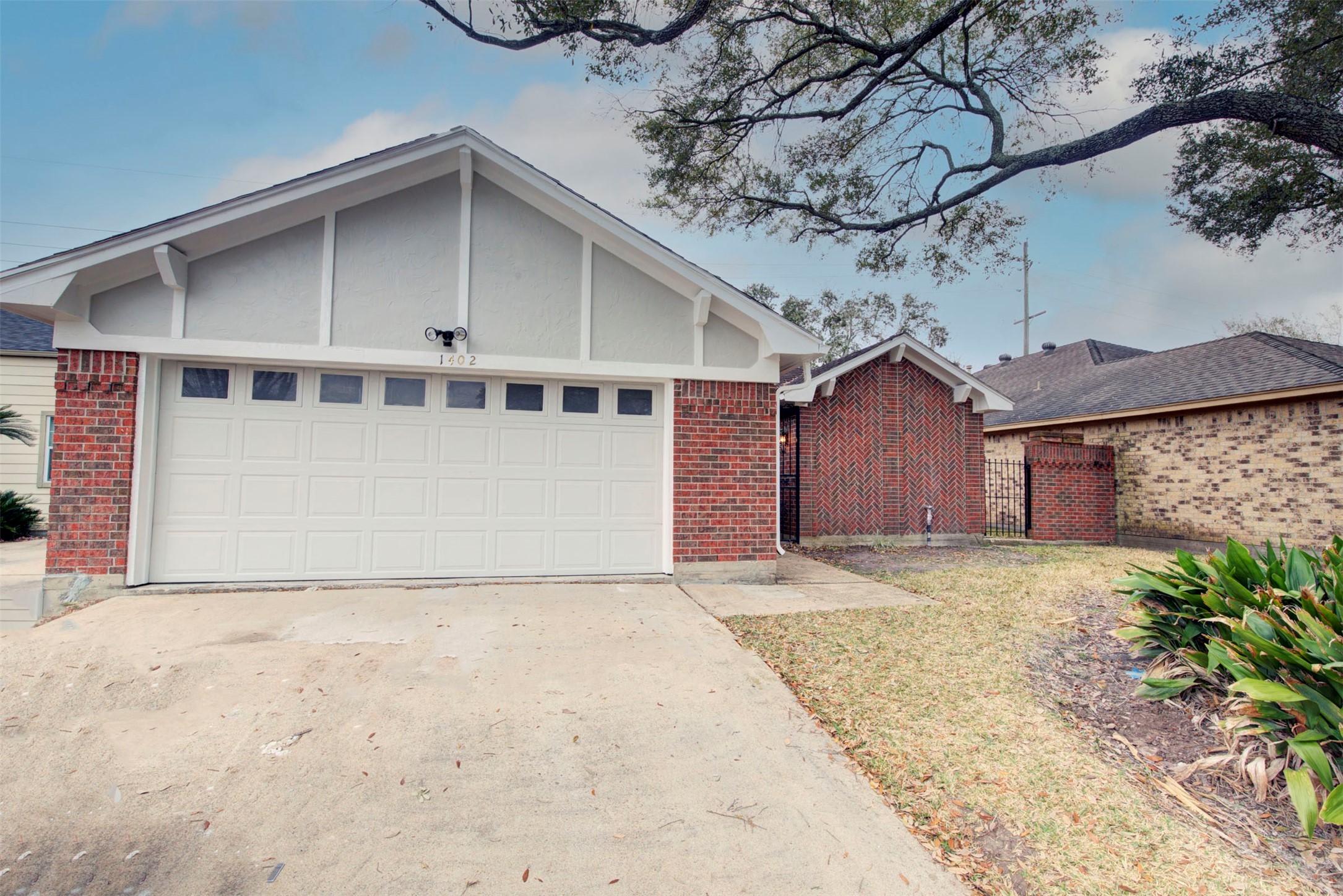 1402 Forest Home Drive Houston, TX 77077 - Photo 3 of 35 a front view of a house with a yard and garage