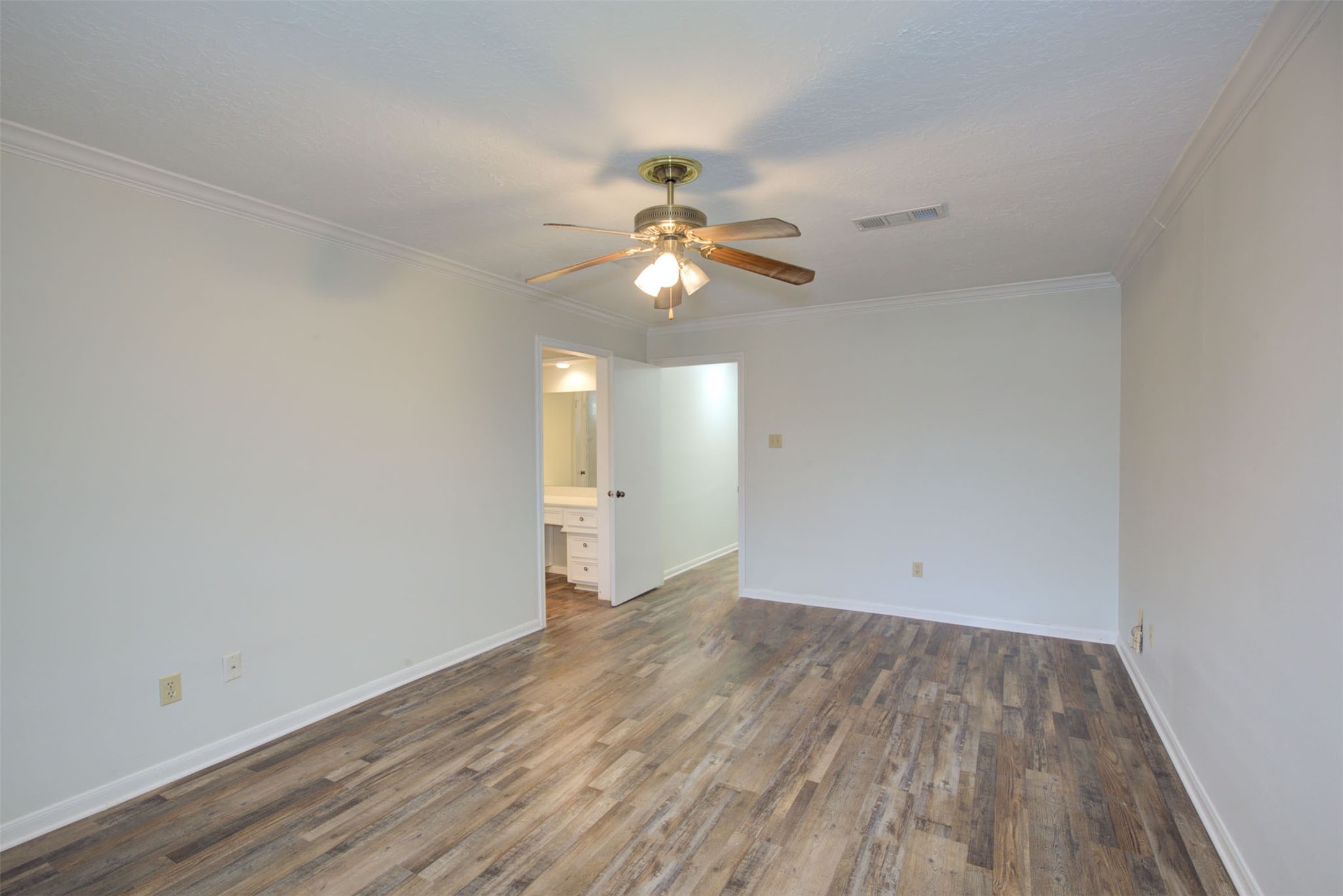 1402 Forest Home Drive Houston, TX 77077 - Photo 32 of 35 a view of a room with wooden floor and a ceiling fan