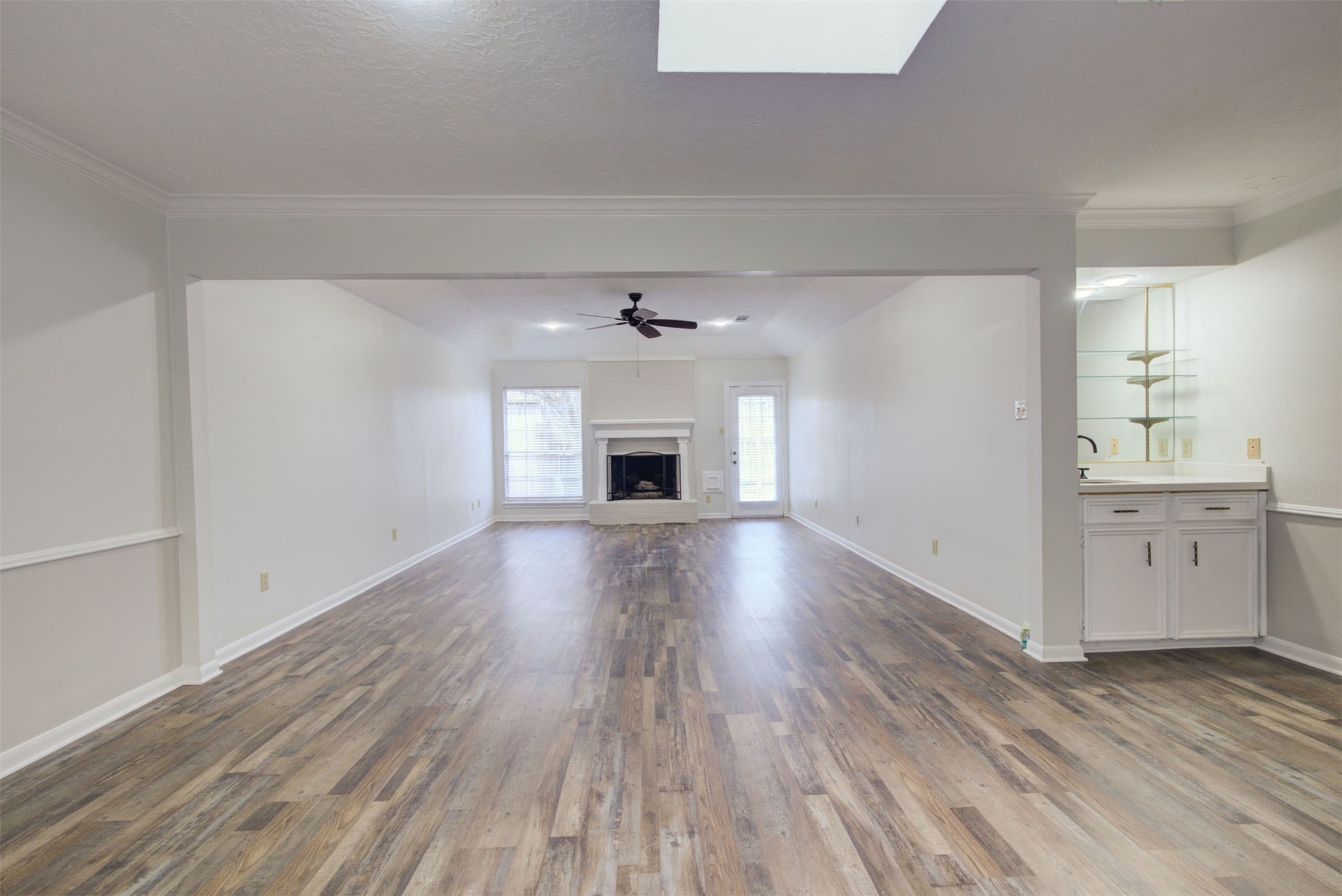 1402 Forest Home Drive Houston, TX 77077 - Photo 5 of 35 wooden floor in an empty room with a fireplace