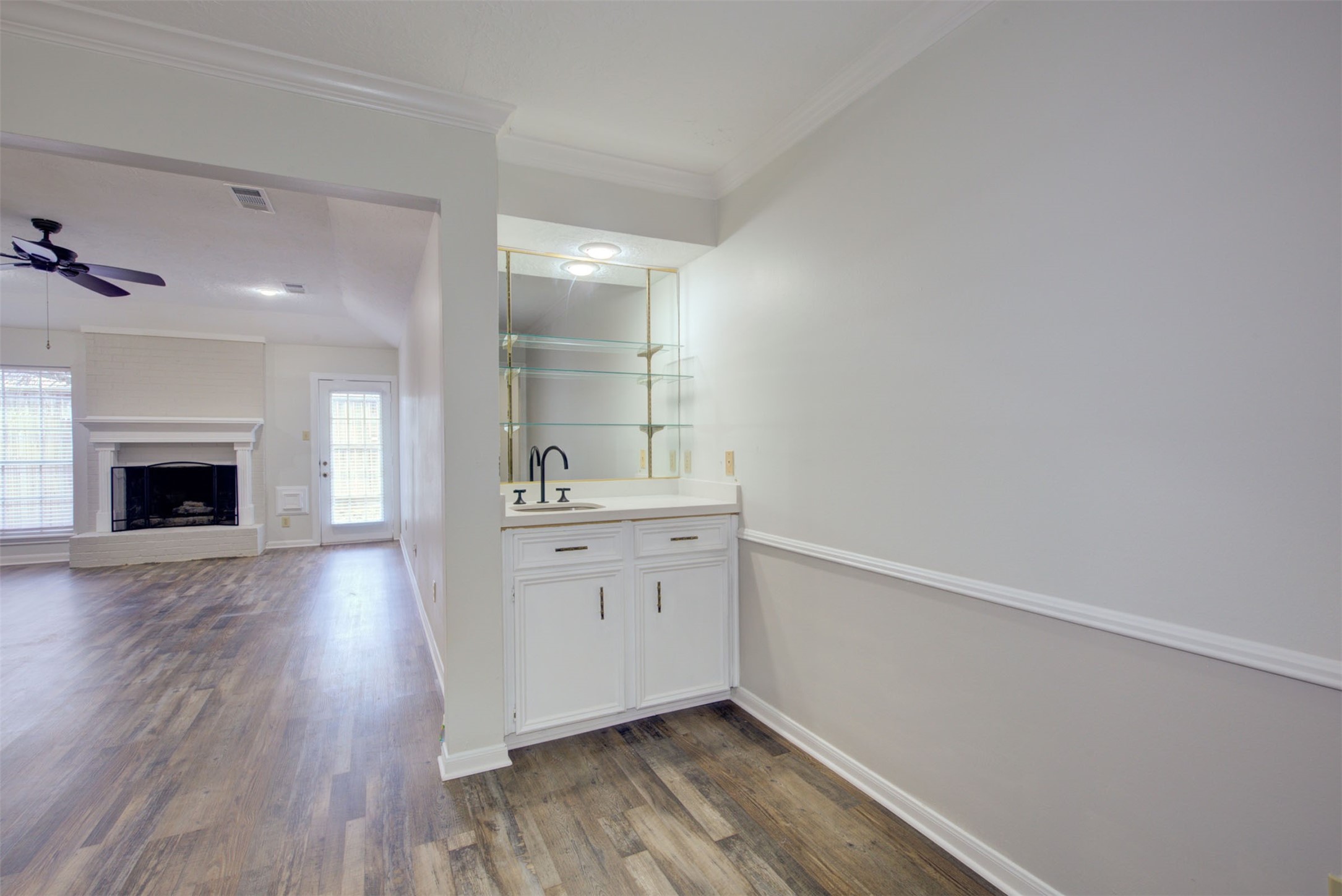 1402 Forest Home Drive Houston, TX 77077 - Photo 6 of 35 a room with a wooden floor and a fireplace