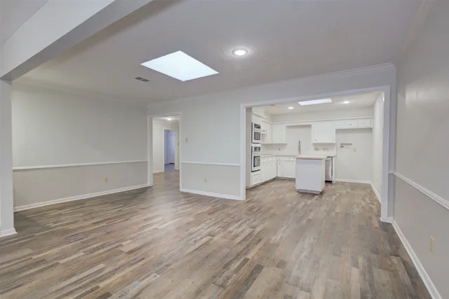 a kitchen with a sink cabinets and wooden floor
