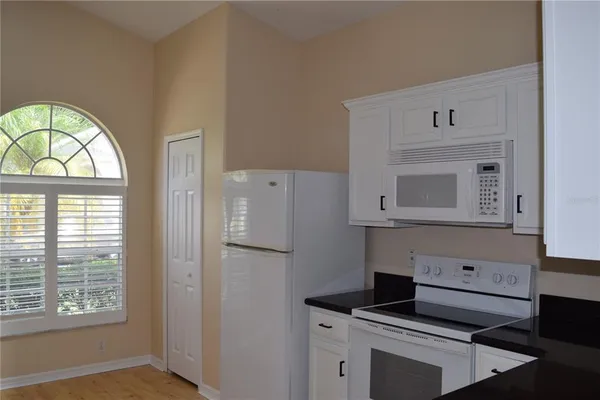 a kitchen with a stove and a window