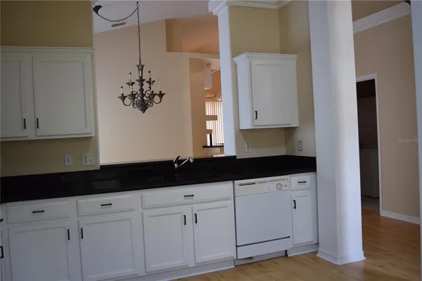 a kitchen with white cabinets and a sink