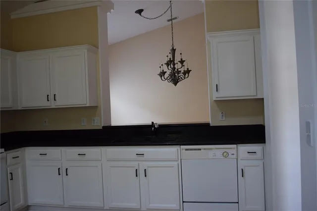 a close view of a bathroom sink and cabinets