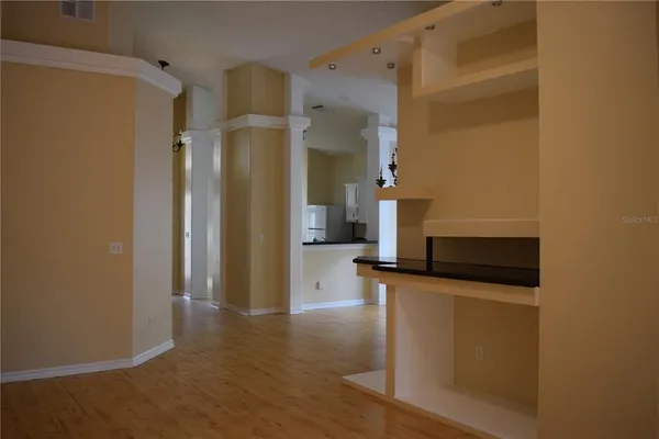 a view of a kitchen from a hallway