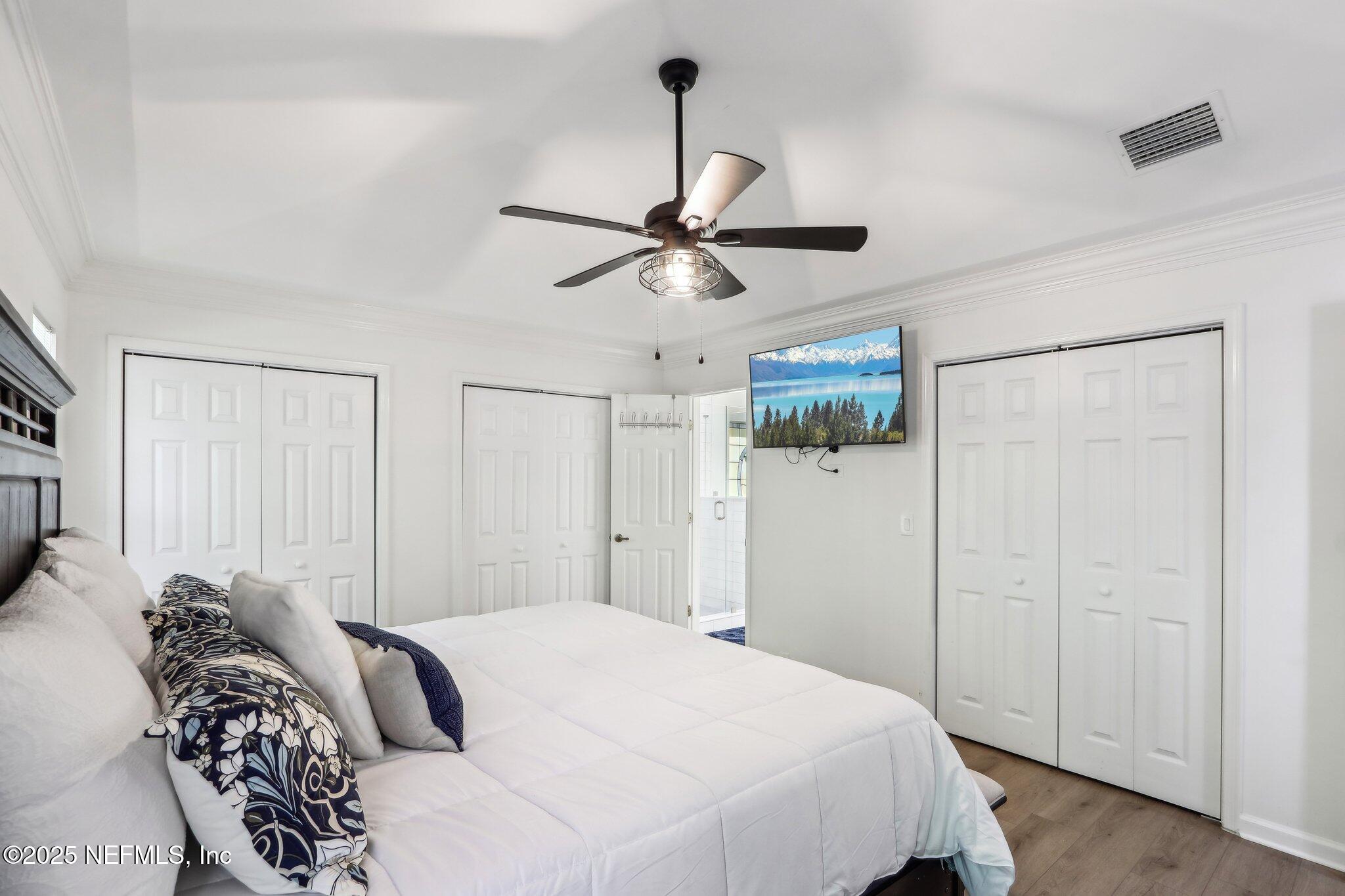 8727 Goodbys Trace Drive Jacksonville, FL 32217 - Photo 17 of 32 a bedroom with a bed ceiling fan and a window