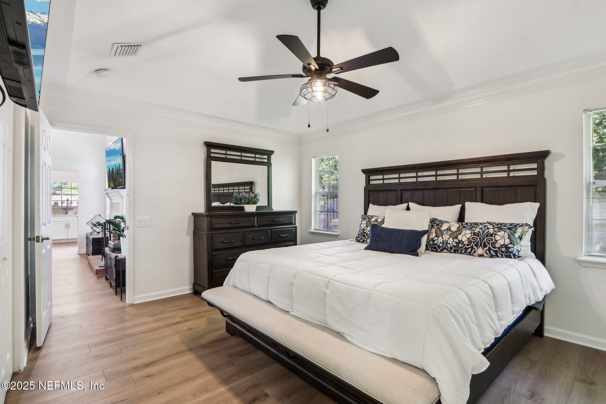 8727 Goodbys Trace Drive Jacksonville, FL 32217 - Photo 18 of 32 a bedroom with a bed and a chandelier