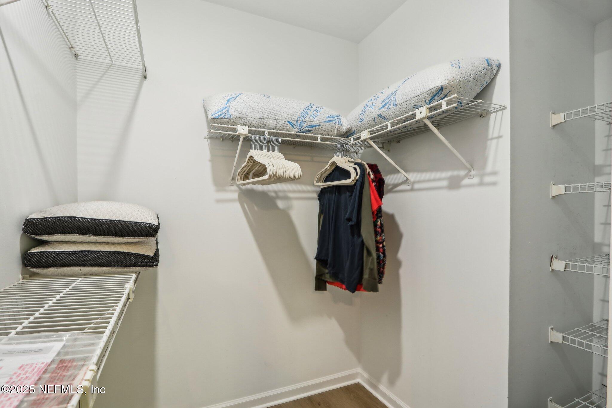 8727 Goodbys Trace Drive Jacksonville, FL 32217 - Photo 19 of 32 a view of walk in closet with clothes and shoes