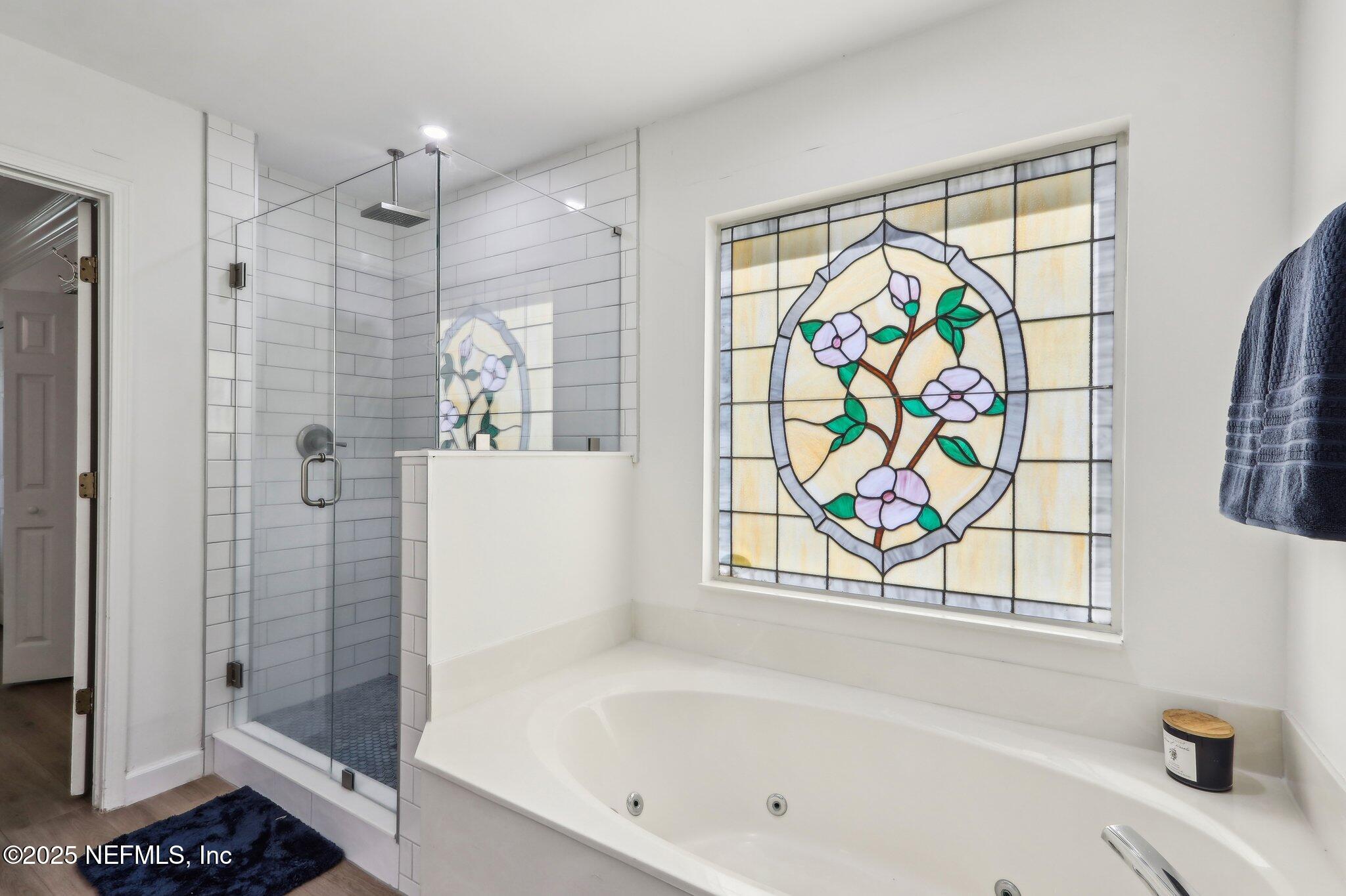 8727 Goodbys Trace Drive Jacksonville, FL 32217 - Photo 20 of 32 a bathroom with a bathtub and a shower