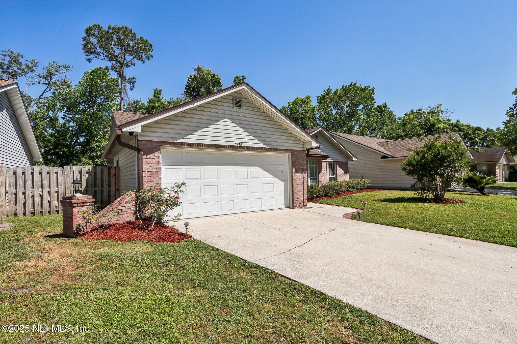 8727 Goodbys Trace Drive Jacksonville, FL 32217 - Photo 2 of 32 a front view of a house with garden