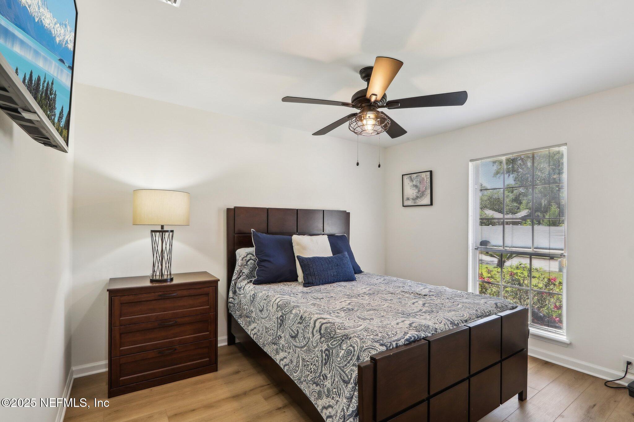 8727 Goodbys Trace Drive Jacksonville, FL 32217 - Photo 24 of 32 a bedroom with a bed and a chandelier