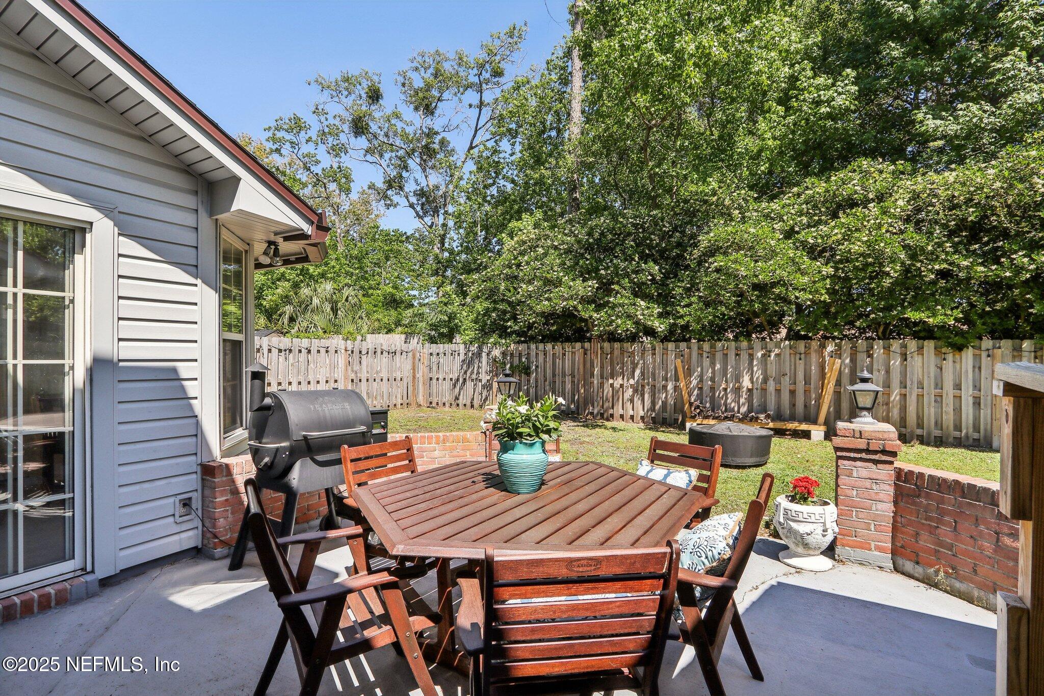 8727 Goodbys Trace Drive Jacksonville, FL 32217 - Photo 28 of 32 a view of a dinning table and chairs in the patio