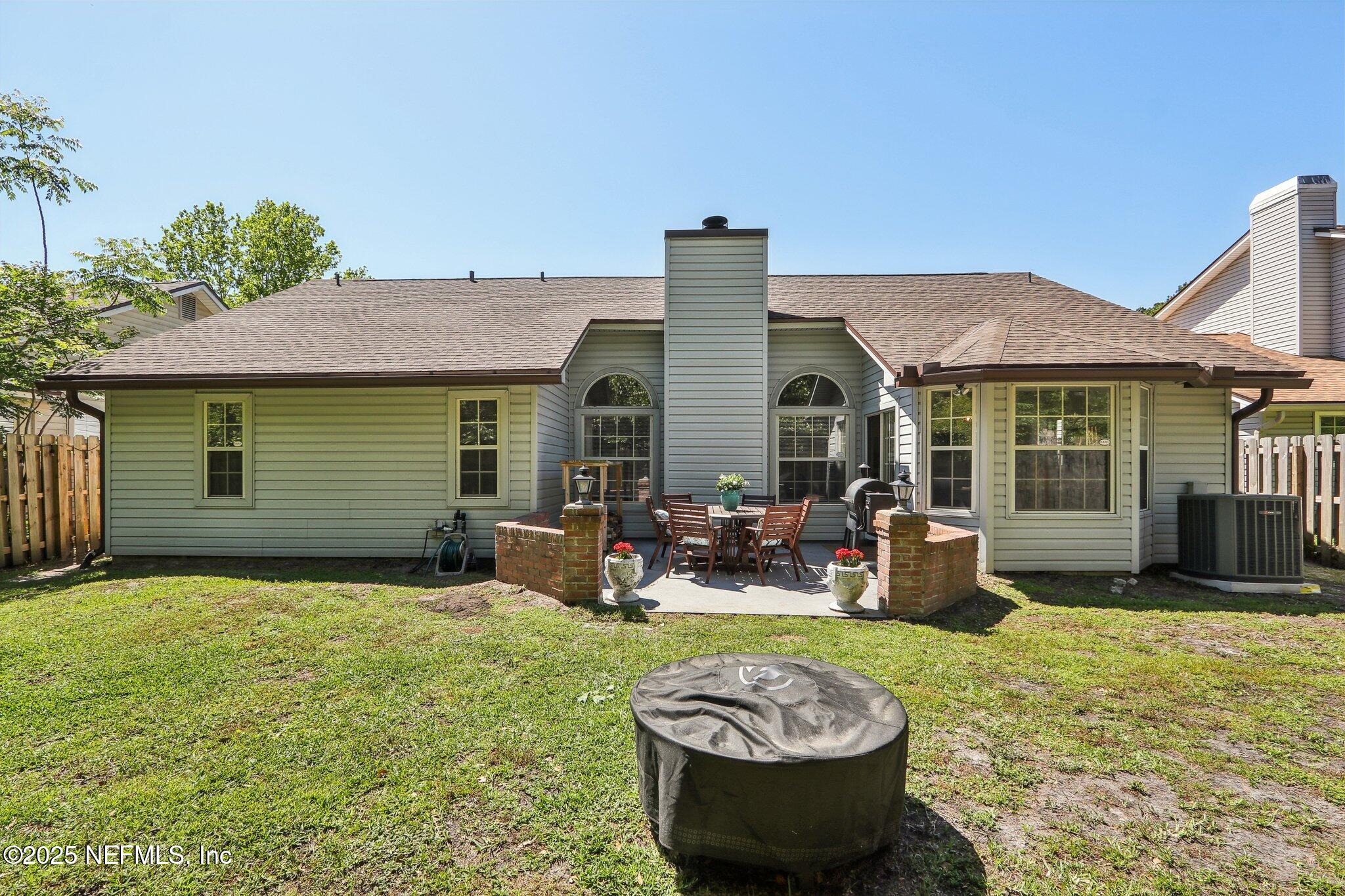 8727 Goodbys Trace Drive Jacksonville, FL 32217 - Photo 30 of 32 a view of a house with backyard sitting area and garden