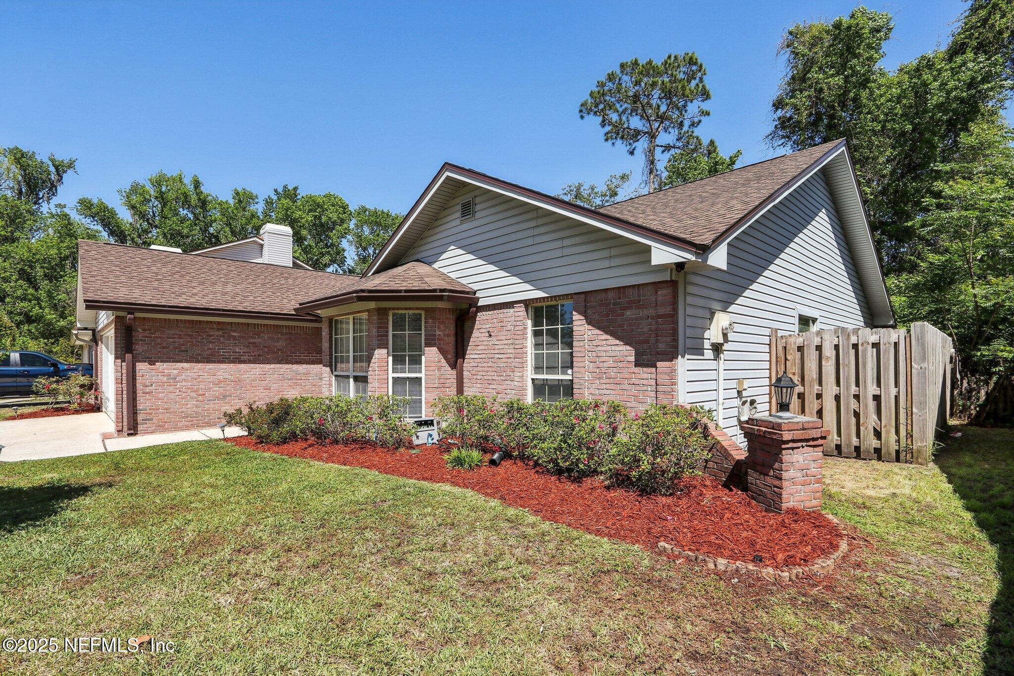 8727 Goodbys Trace Drive Jacksonville, FL 32217 - Photo 3 of 32 a front view of a house with garden