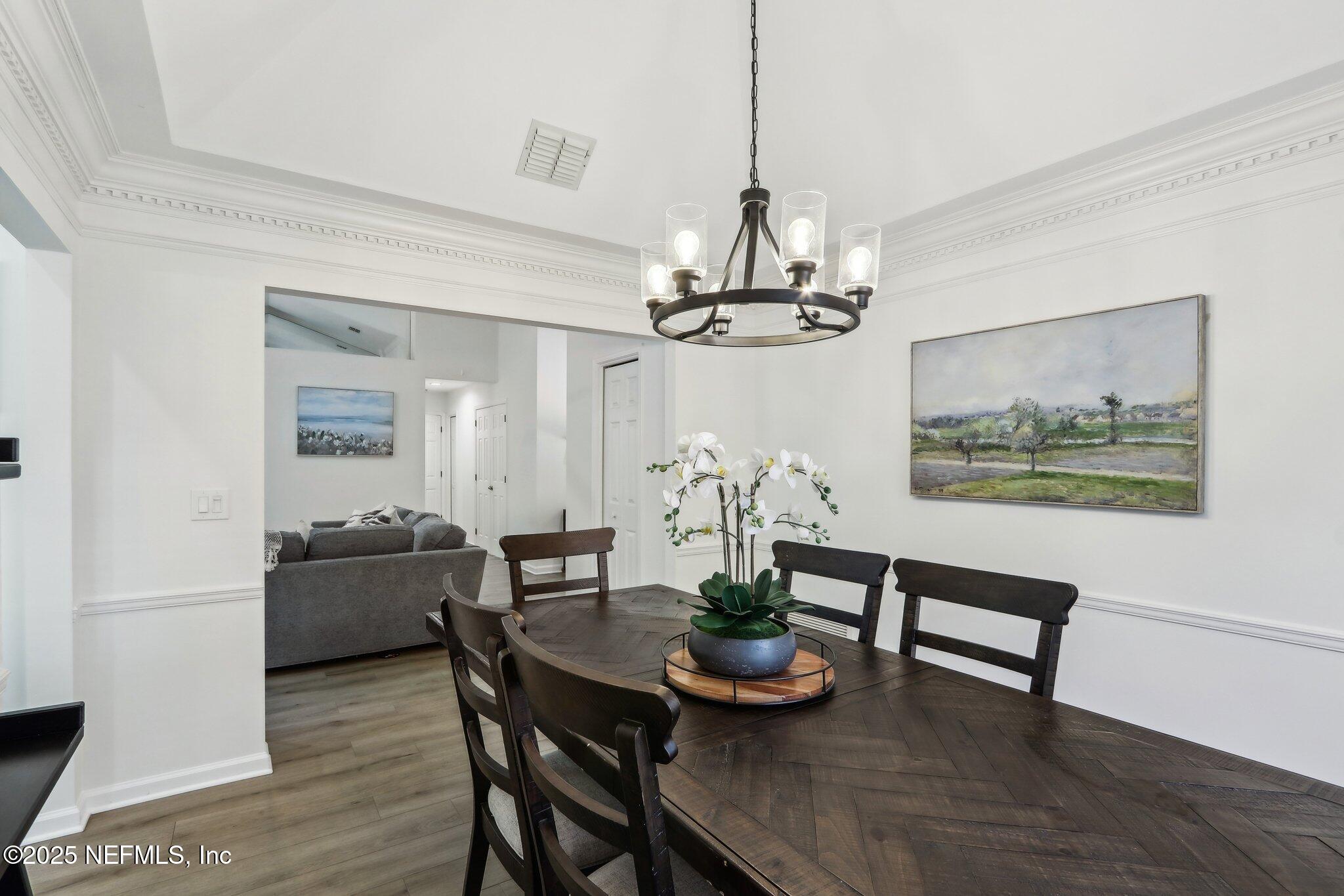 8727 Goodbys Trace Drive Jacksonville, FL 32217 - Photo 10 of 32 a view of a dining room with furniture and wooden floor