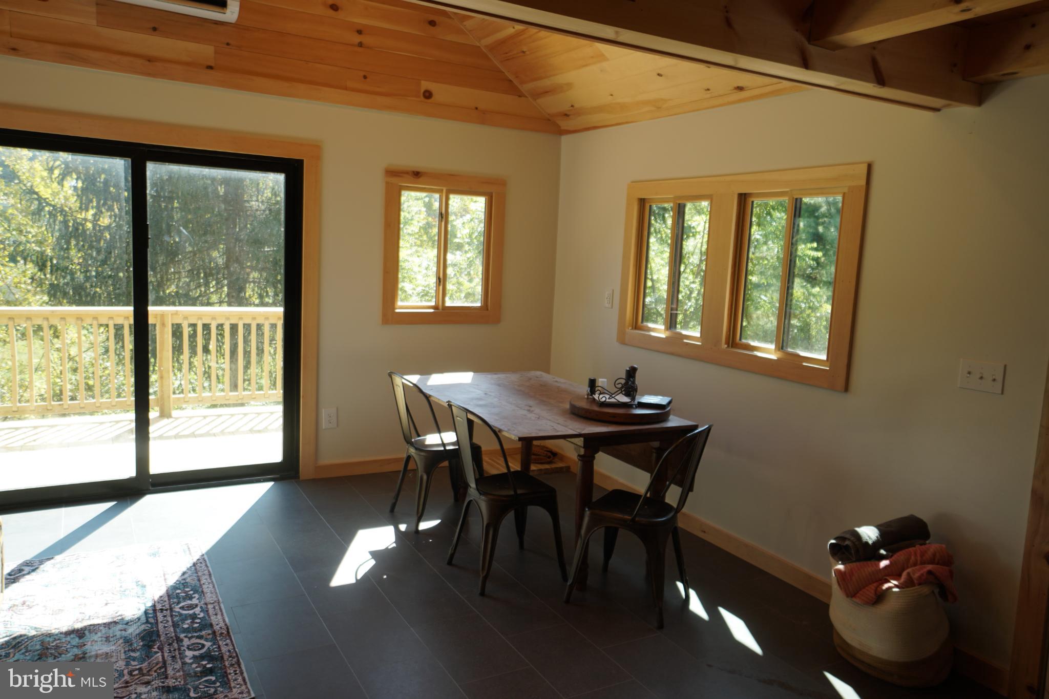 789 Upper South Branch Road Franklin, WV 26807 - Photo 21 of 50 a view of a dining room with furniture window and outside view