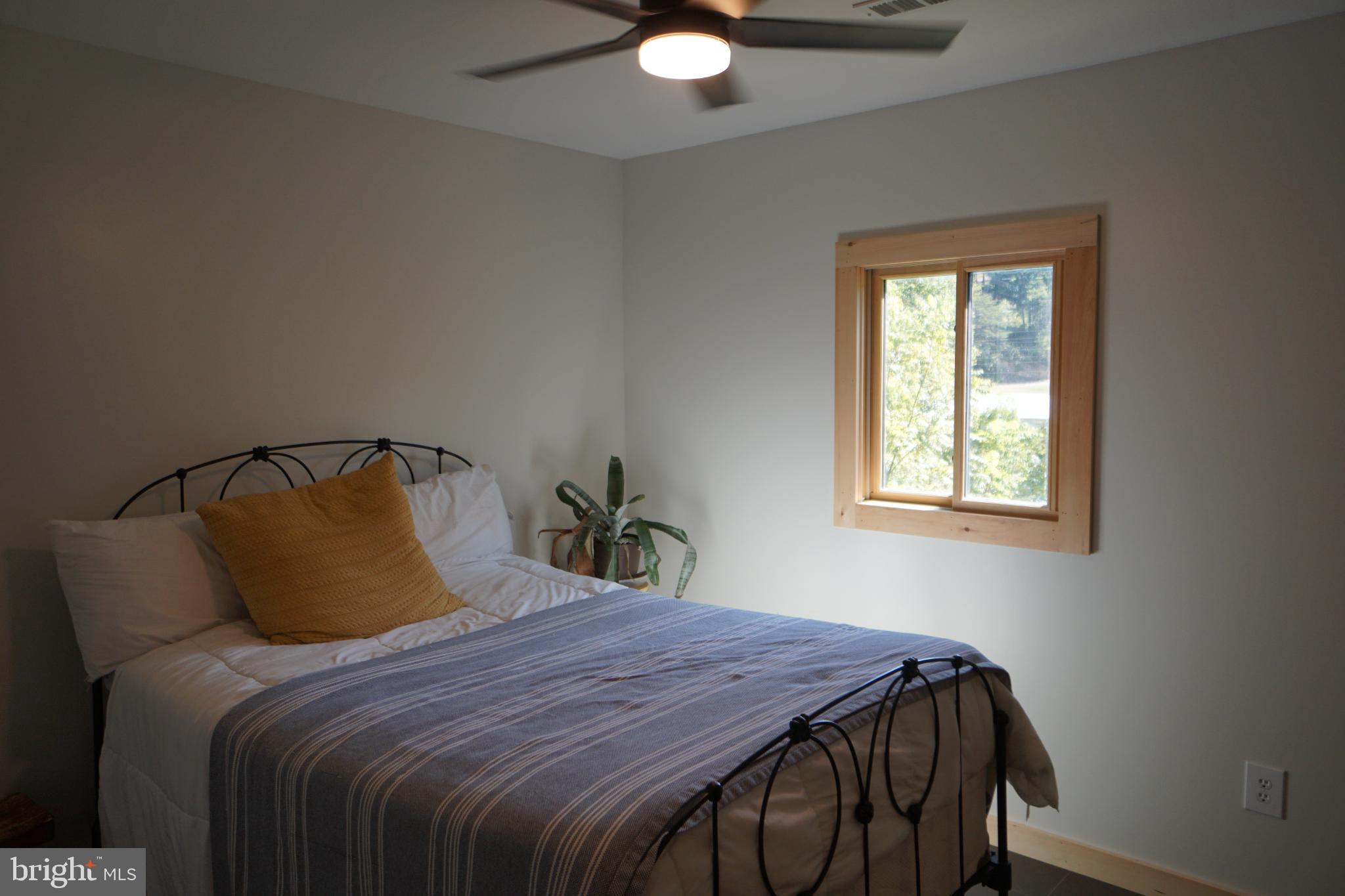 789 Upper South Branch Road Franklin, WV 26807 - Photo 5 of 50 a bedroom with a bed and a window
