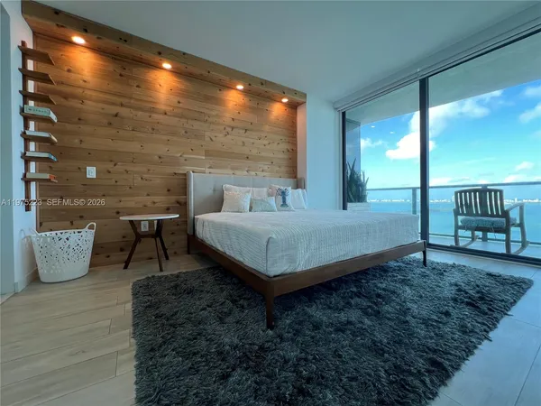 a bed sitting in a bedroom next to a window