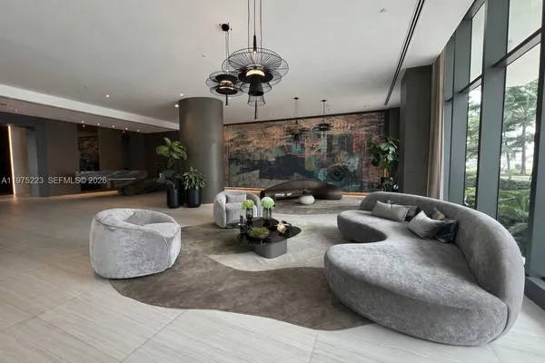 a living room with furniture and large windows