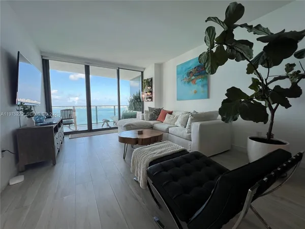 a view of living room with furniture and wooden floor