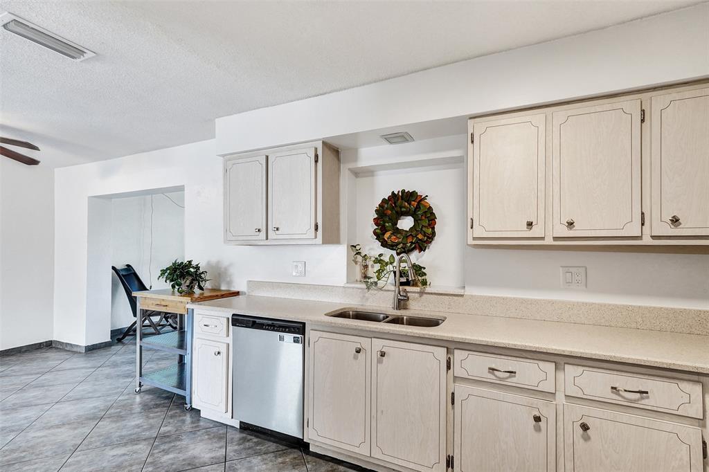 7003 Northwest 95th Terrace Tamarac, FL 33321 - Photo 13 of 44 a kitchen with a sink and cabinets