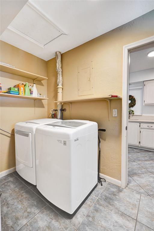 7003 Northwest 95th Terrace Tamarac, FL 33321 - Photo 17 of 44 a utility room with dryer and washer