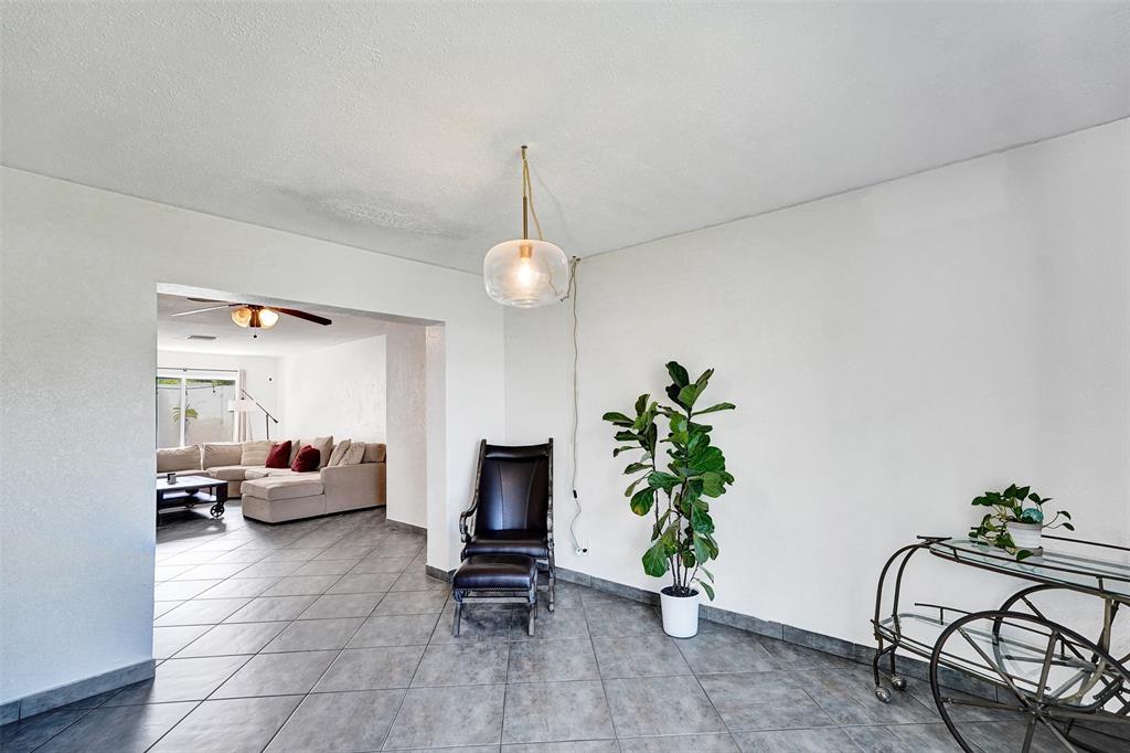 7003 Northwest 95th Terrace Tamarac, FL 33321 - Photo 20 of 44 a living room with furniture and flowers