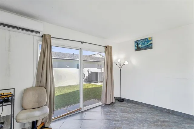 a view of room with window and hallway