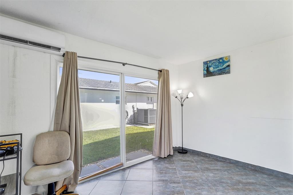 7003 Northwest 95th Terrace Tamarac, FL 33321 - Photo 22 of 44 a view of room with window and hallway