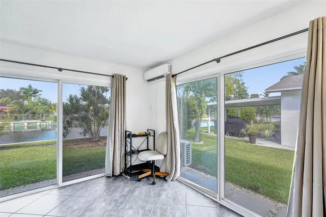 a view of a room with a big yard and a porch