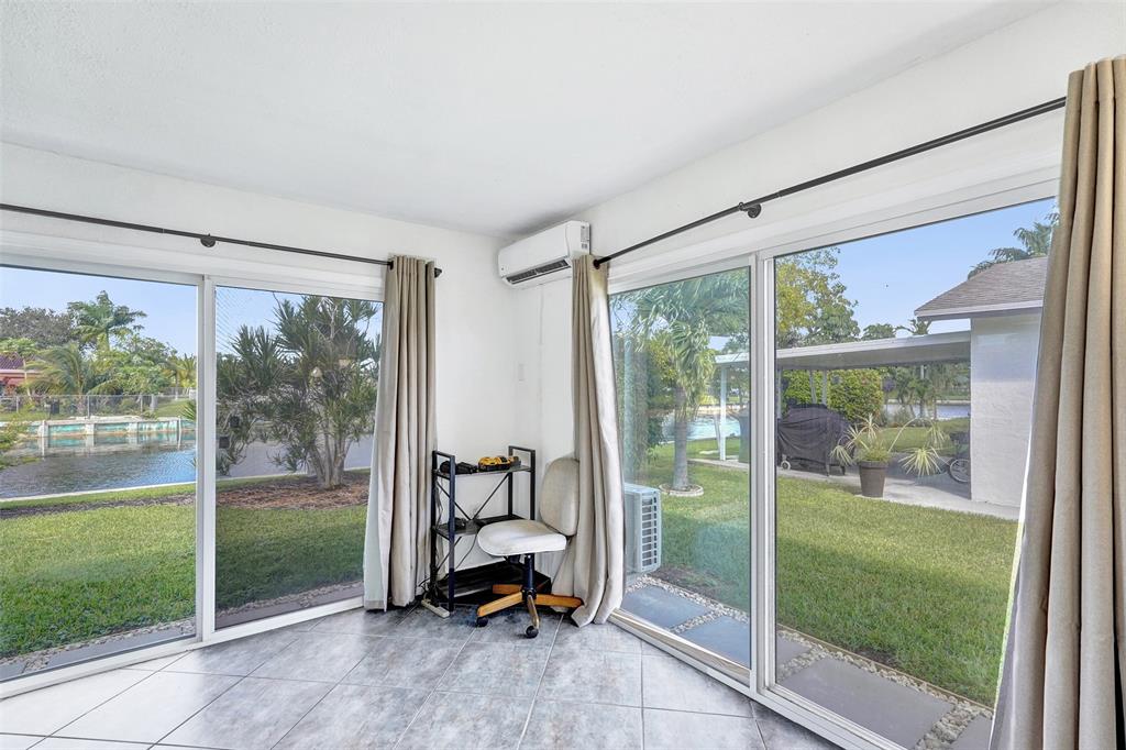 7003 Northwest 95th Terrace Tamarac, FL 33321 - Photo 23 of 44 a view of a room with a big yard and a porch