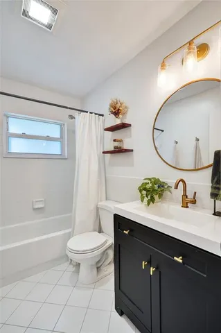 a bathroom with a granite countertop sink a toilet and a mirror