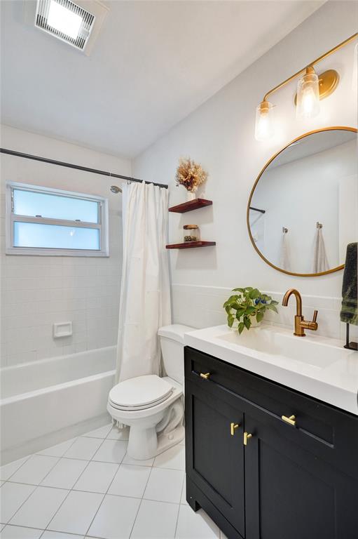 7003 Northwest 95th Terrace Tamarac, FL 33321 - Photo 26 of 44 a bathroom with a granite countertop sink a toilet and a mirror
