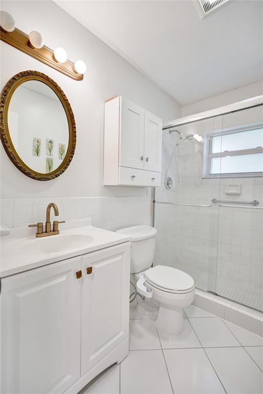 7003 Northwest 95th Terrace Tamarac, FL 33321 - Photo 28 of 44 a bathroom with a sink a toilet and a mirror