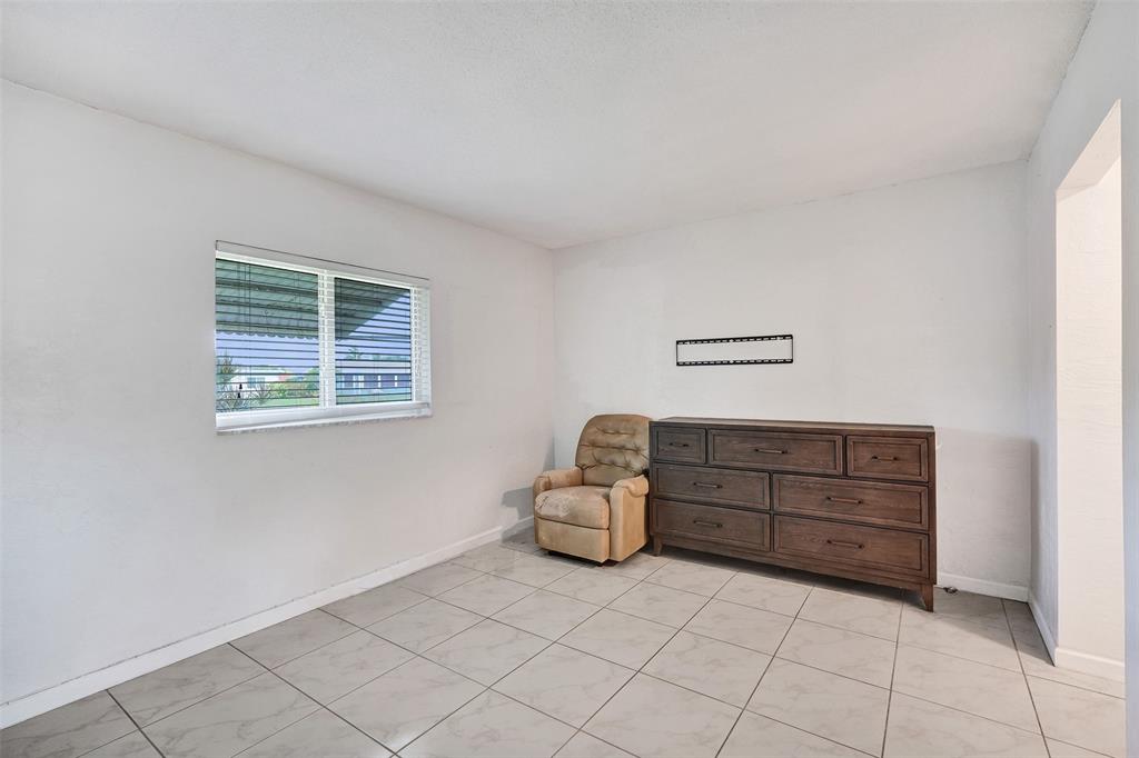 7003 Northwest 95th Terrace Tamarac, FL 33321 - Photo 32 of 44 a bedroom with a bed and a window