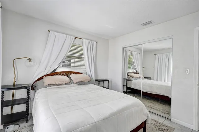 a bedroom with a bed and a window