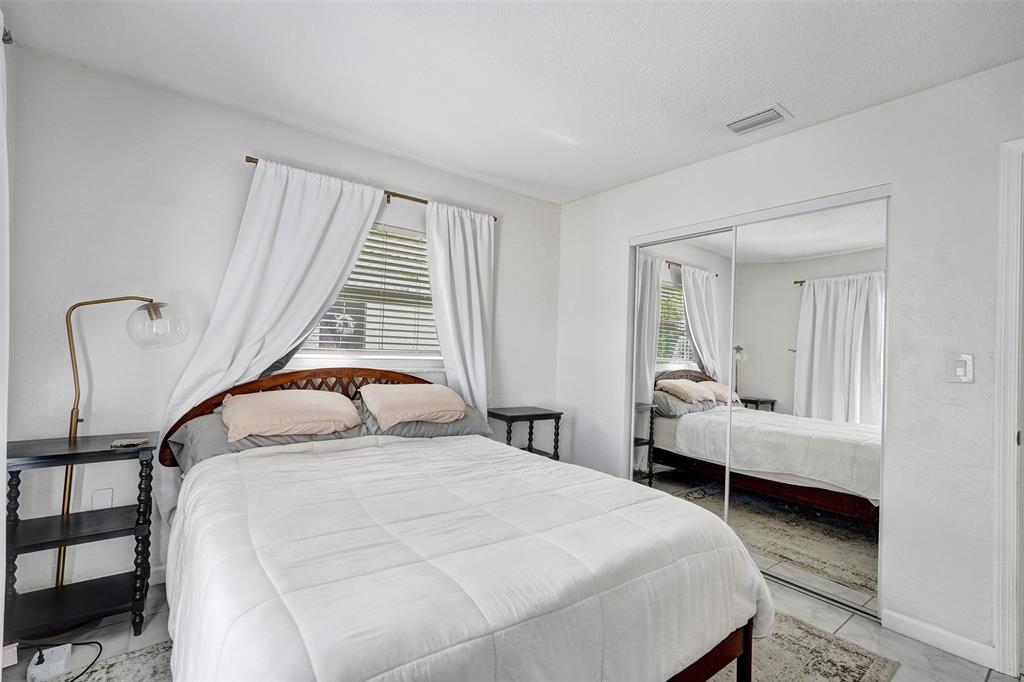 7003 Northwest 95th Terrace Tamarac, FL 33321 - Photo 34 of 44 a bedroom with a bed and a window