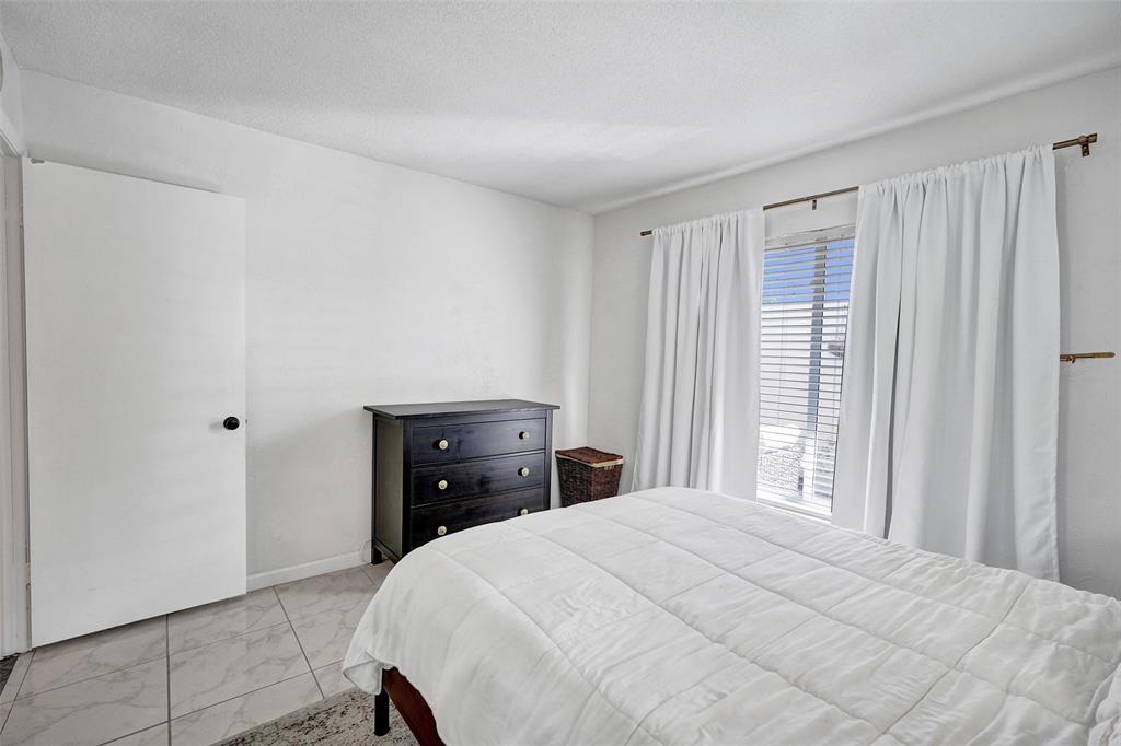 7003 Northwest 95th Terrace Tamarac, FL 33321 - Photo 35 of 44 a bedroom with a bed and window