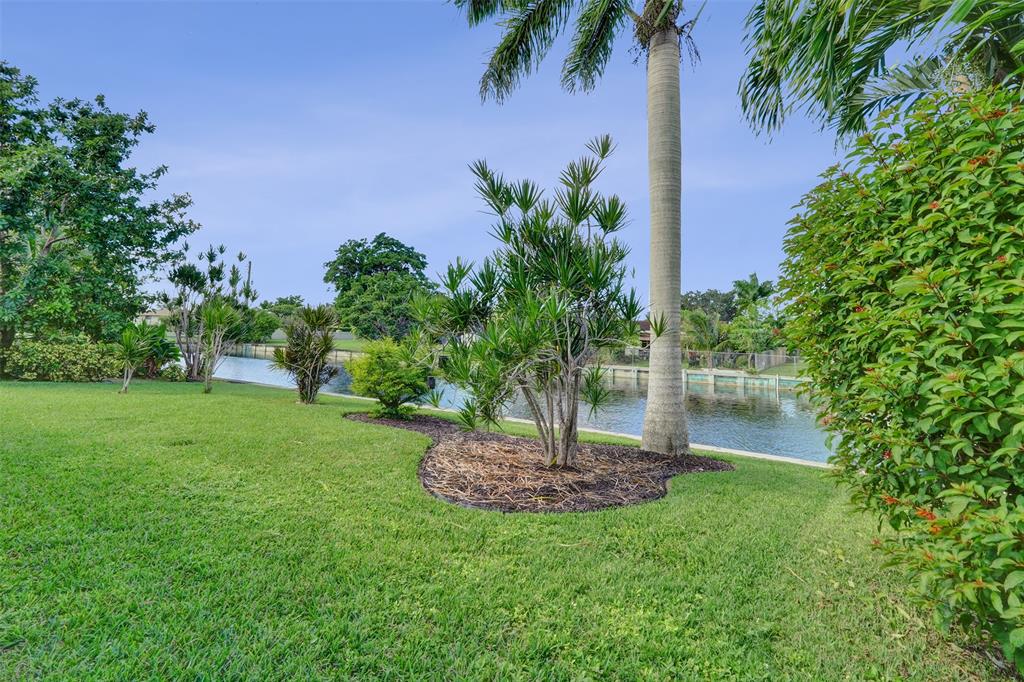 7003 Northwest 95th Terrace Tamarac, FL 33321 - Photo 37 of 44 a view of a garden with a fountain
