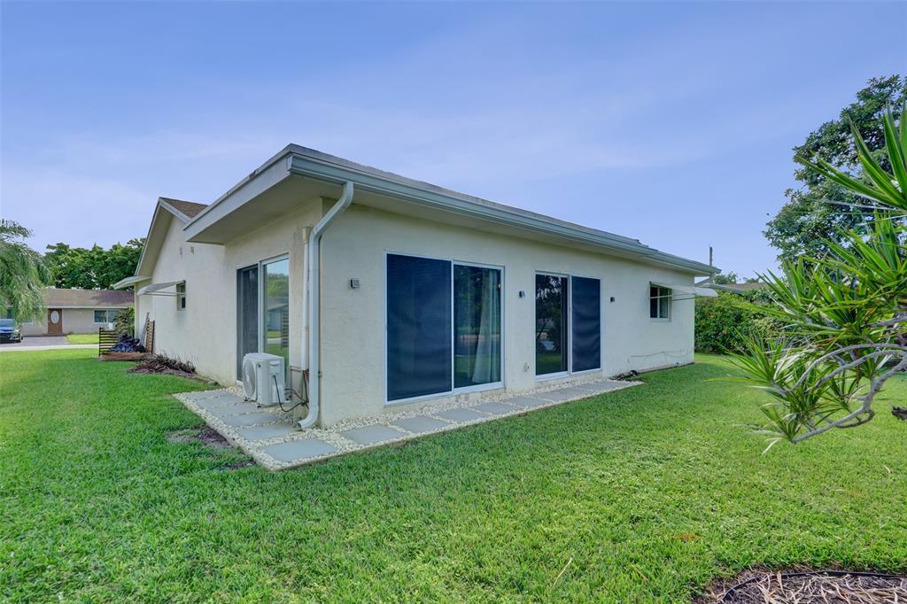 7003 Northwest 95th Terrace Tamarac, FL 33321 - Photo 38 of 44 a view of a house with a yard