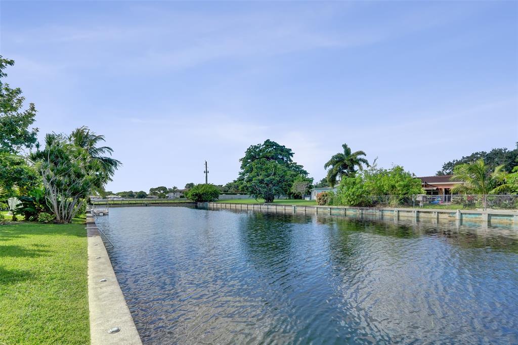 7003 Northwest 95th Terrace Tamarac, FL 33321 - Photo 40 of 44 a view of a lake with houses in the back