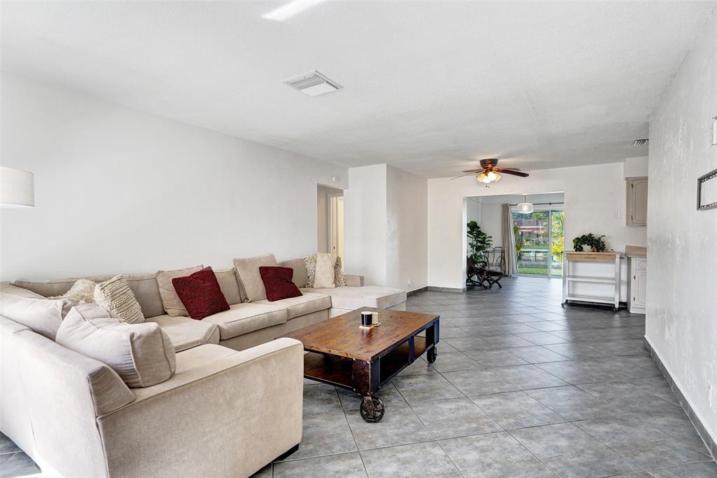 7003 Northwest 95th Terrace Tamarac, FL 33321 - Photo 9 of 44 a living room with furniture and wooden floor