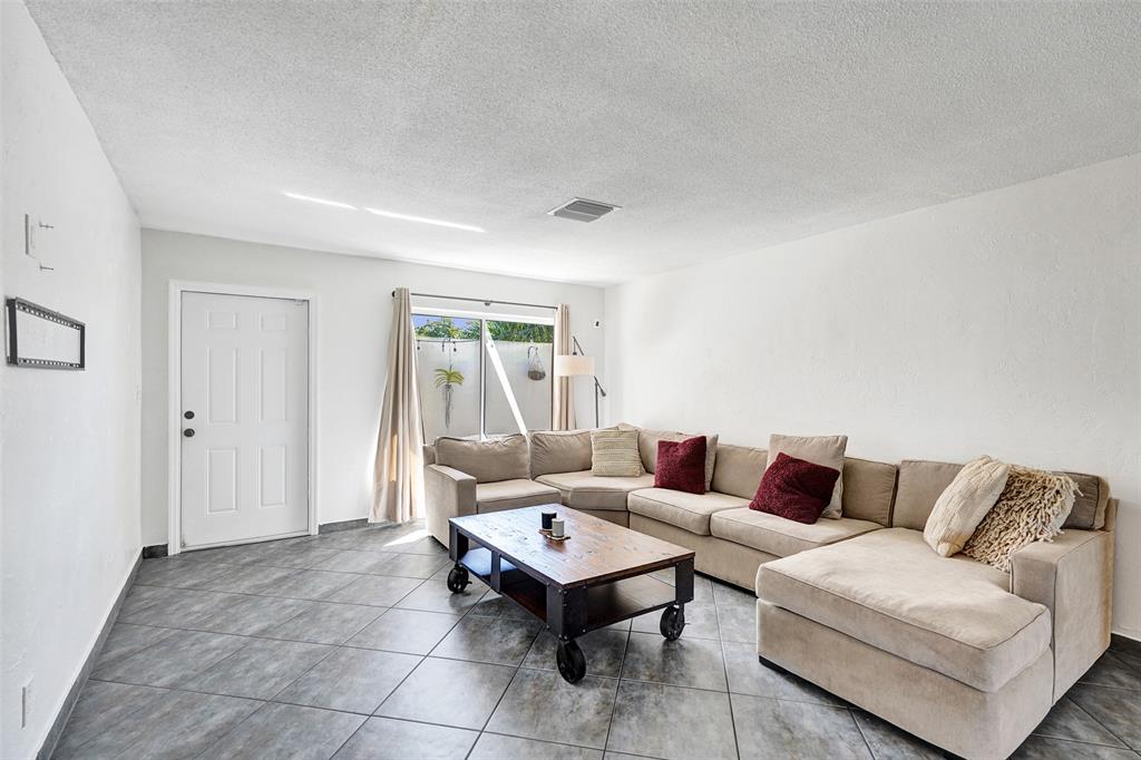 7003 Northwest 95th Terrace Tamarac, FL 33321 - Photo 10 of 44 a living room with furniture and a couch