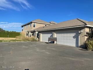 2104 Birchfield Road Yakima, WA 98901 - Photo 2 of 4 a front view of a house with a road