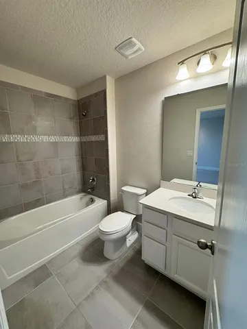 a bathroom with a toilet a sink and bathtub