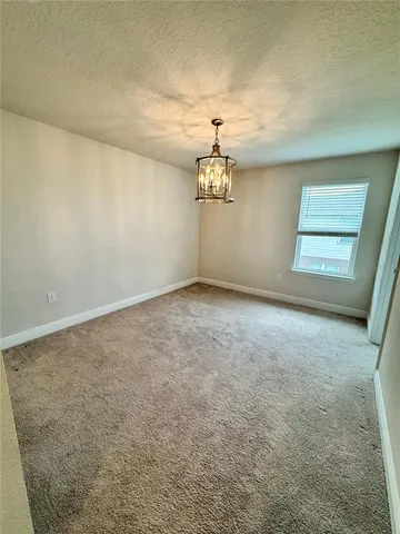 an empty room with a chandelier