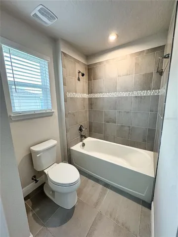 a bathroom with a bathtub and toilet