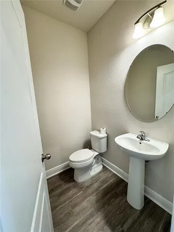 a bathroom with a sink toilet and mirror