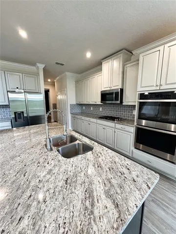 a kitchen with granite countertop a sink and counter space