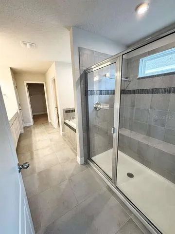 a bathroom with a glass shower door